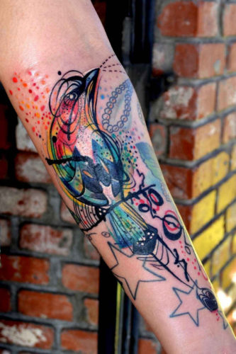 This-colorful-bird-tattoo-by-Petra-works-a-charm-to-pull-together-the-clients-existing-tattoos